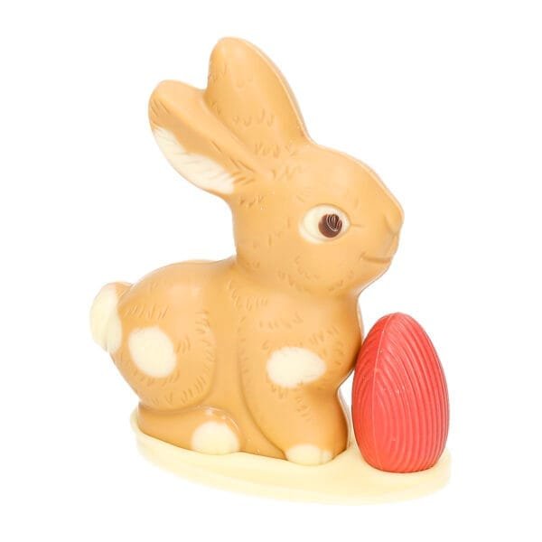 Sitting bunny small with egg, white with caramel - chocolate Easter bunny - 8021040 1 scaled